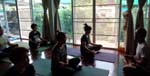 conducting a yoga class with the Sivananda yogis of Chiang Rai