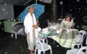 Rem and Kathy braving typhoon Santi at dawn to ready a make-shift breakfast area for the meditators
