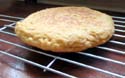 the bread is done if it sounds hollow when you tap on it. Put it on a wire rack to keep it from getting soggy