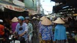 busy market scene with women wearing their conical hat