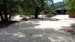 the shaded beach area with picnic tables