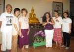with lay friends by Buddha